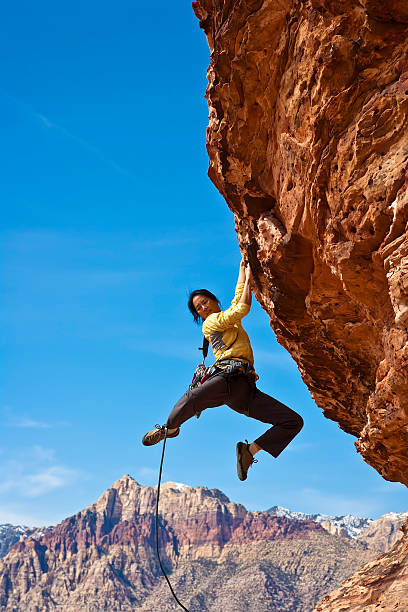 istock Female rock climber reaching for the summit. 147272420
