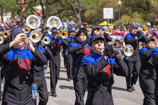 San Antonio, Texas, USA - April 8, 2022: The Battle of the Flowers Parade, The Teodore Roosevelt High School Rough Rider Band performing at the parade