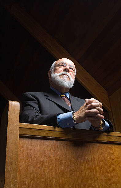 istock Older Caucasian Man Praying in Church Pew 147272475