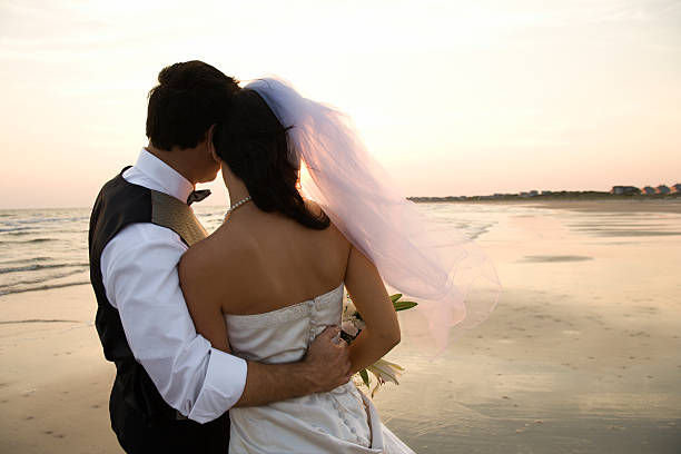 istock Newlywed Couple on Beach 147272696