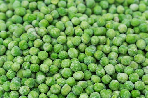 group of frozen green peas closeup selective focus