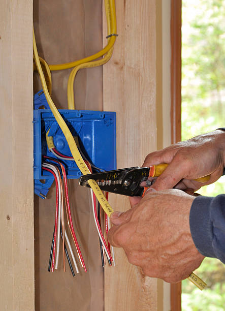 istock Electrician's hand stripping insulation off of a wire 147272935