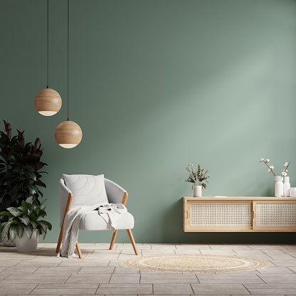Interior mockup green wall with gray armchair and decor in living room.3d rendering