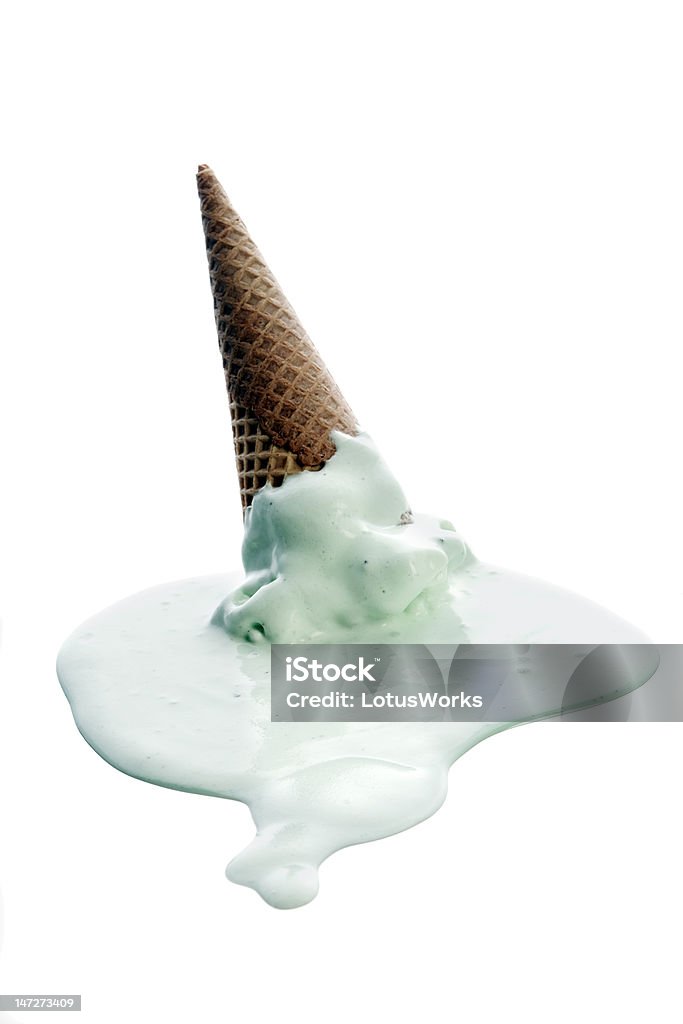 Ice cream Ice cream cone turned upside down with melting pistachio ice cream on white background. Melting Stock Photo