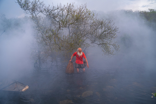 Old fisherman in Ru Cha forest - a mangrove forest in leaf changing season - Huong Phong, Huong Tra, Thua Thien Hue province