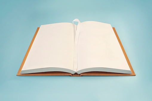 Open book of blank pages on a blue background. top view. copy space
