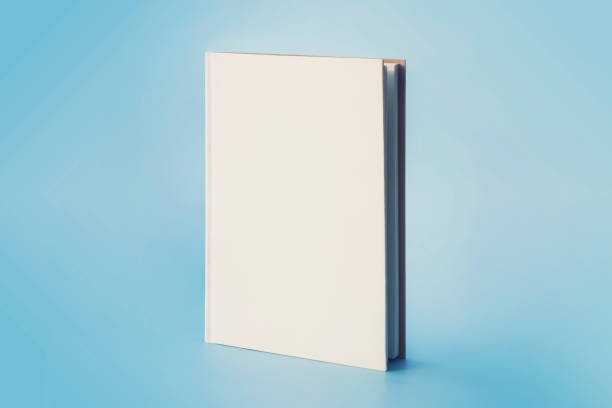 istock a white book on a blue background. Empty space on cover for design and text 1472738068