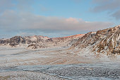 beautiful sunrise over the highlands in Iceland with the snowy mountains in the background with a beautiful dawn.