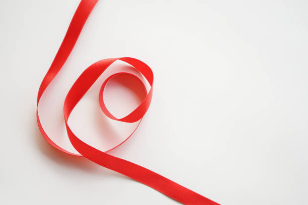 istock red satin ribbon on white background 1472739053