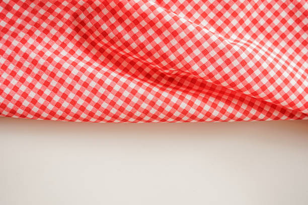 istock Pink plaid fabric or tablecloth on white background with copy space. 1472739055