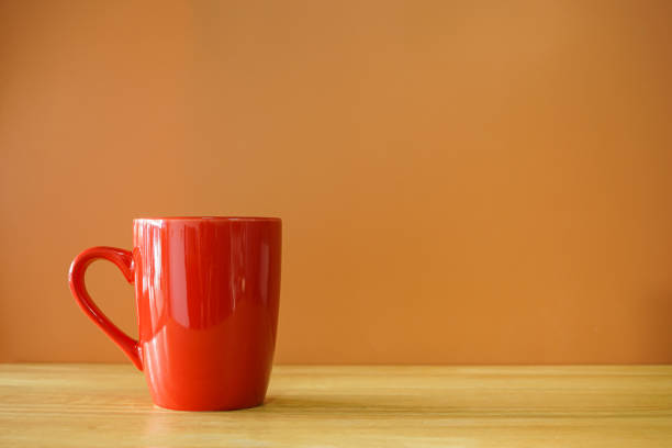 istock Red coffee cup on wooden desk with brown background 1472739063