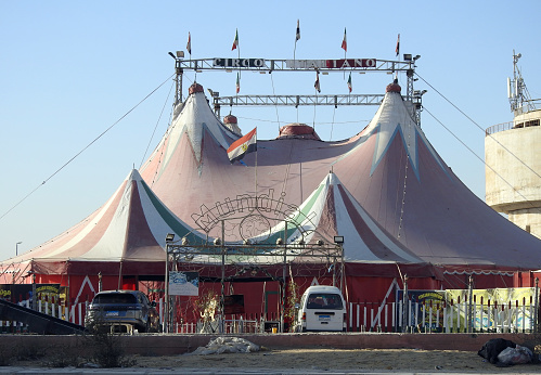 Cairo, Egypt, March 11 2023: Mundial circo Italiano, The Italian circus in Egypt New Cairo with the Italian and Egyptian flags, Tents of an entertainment circus of animals and show in the street, selective focus