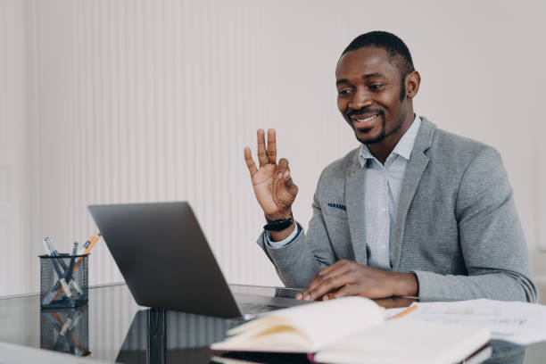 istock African teacher working online at home office and has lesson in sign language. E-learning concept. 1472740984