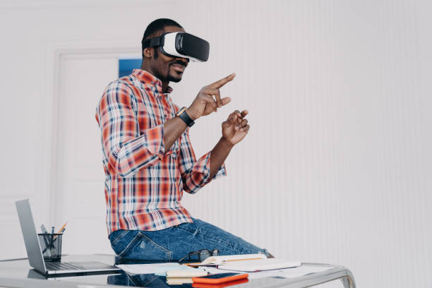 istock African american student in vr glasses at home. Young businessman has remote virtual study. 1472741034
