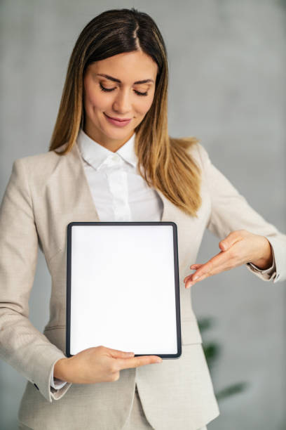 istock Young businesswoman showing digital tablet 1472742194