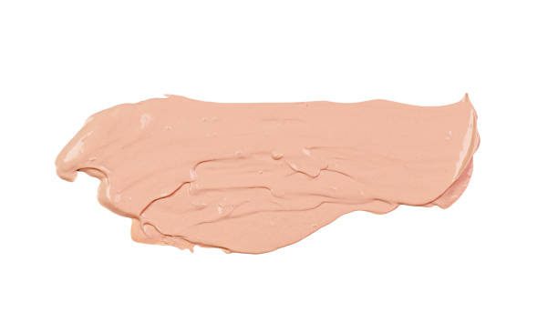 istock Abstract smear of beige makeup foundation, tonal cream isolated on white as sample 1472743521