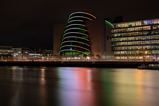 The lights of the Dublin Convention Centre reflected in the river Liffey at night, Dublin, Ireland