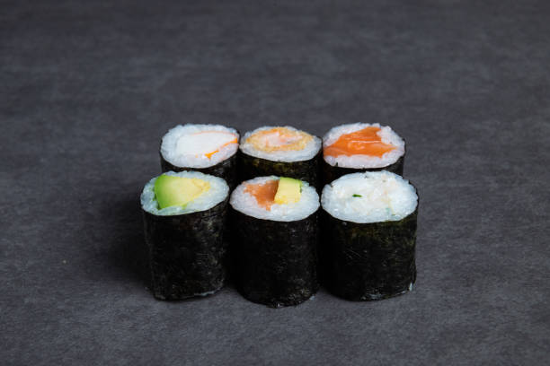 istock Sushi rolls on a black background, close-up, top view 1472743670