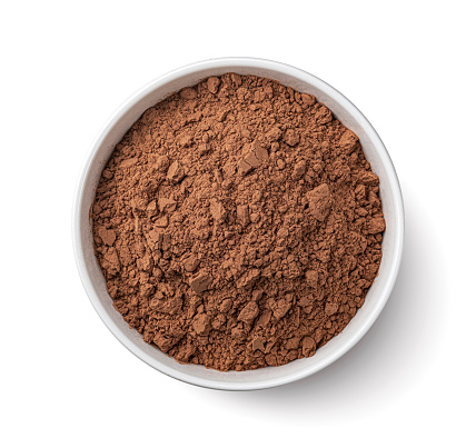 Cocoa powder in bowl isolated on white background, top view