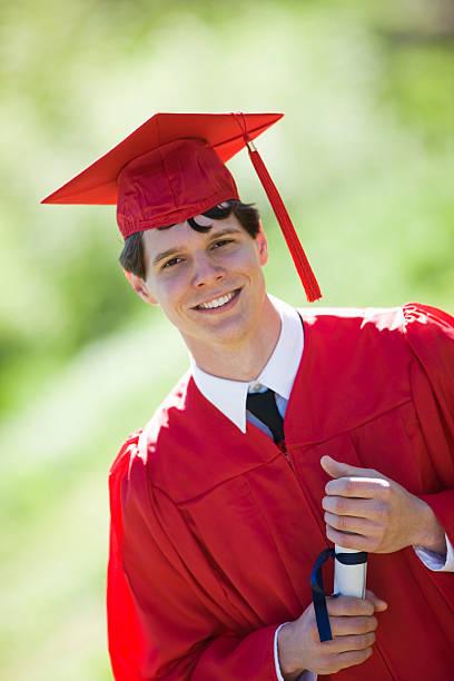 istock Young Man Wearing Graduation Cap And Gown 147274514