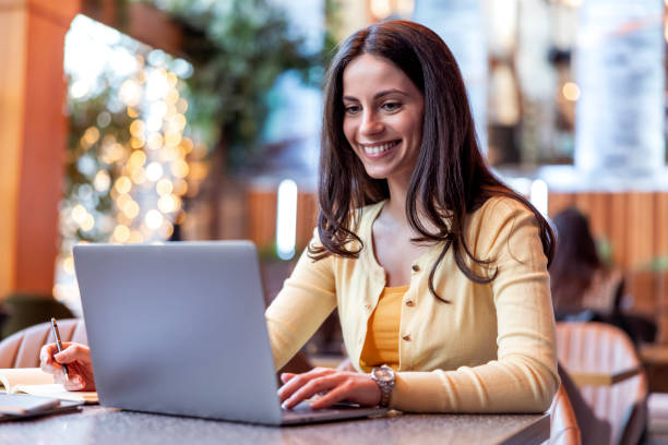 istock Business  woman using laptop at cafe 1472747120