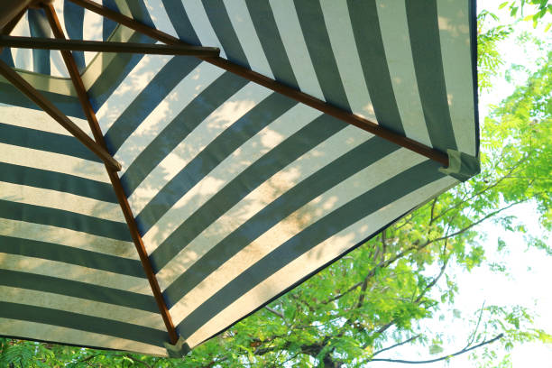 istock Striped beach umbrella on the sunny day 1472747218