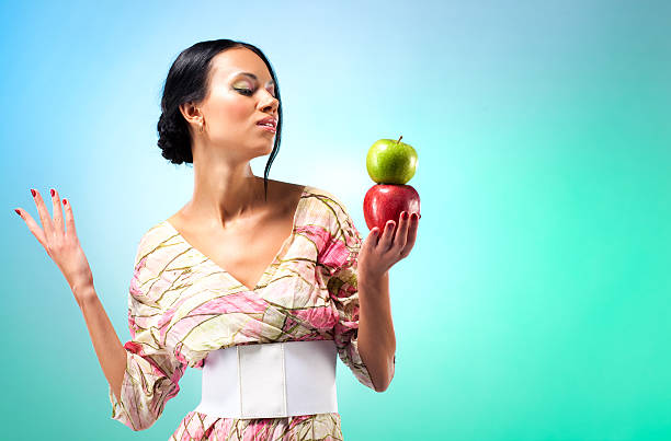 istock Young woman with two apples 147274741