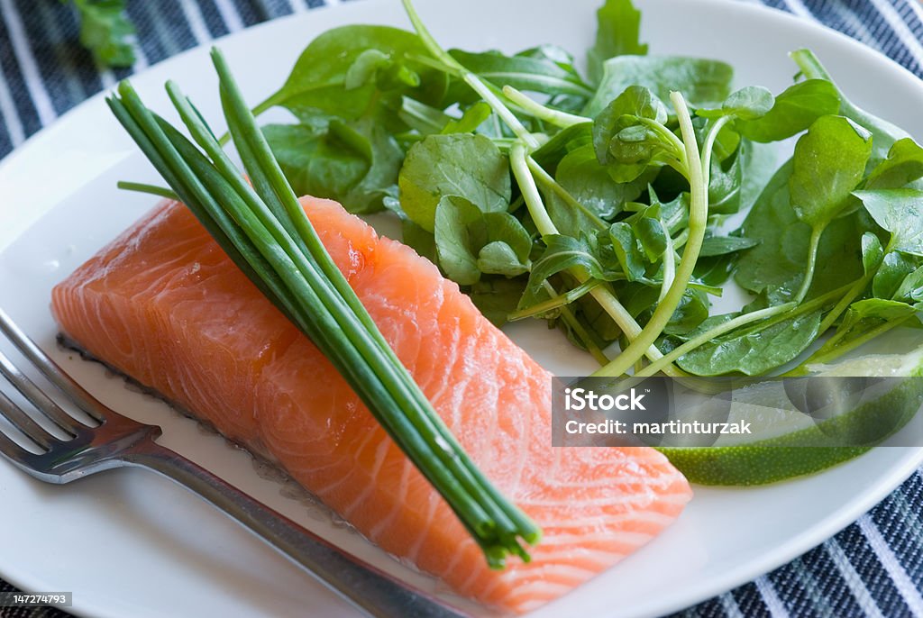 Salmon with spinach Salmon with chives and spinach on a plate Baked Salmon Stock Photo