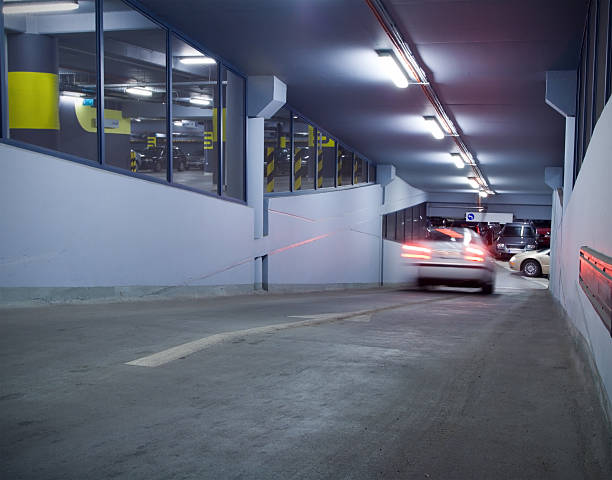 Traffic in underground parking garage. Motion blur from moving car. Number plates and trademarks erased.