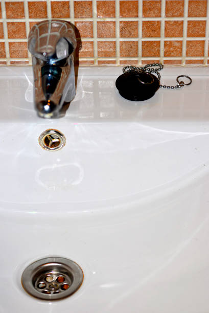 istock drain basin with tap and stopper. White bathroom sink. 1472748841