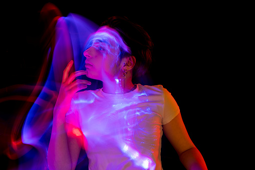 Silhouette of young woman with light painting trails