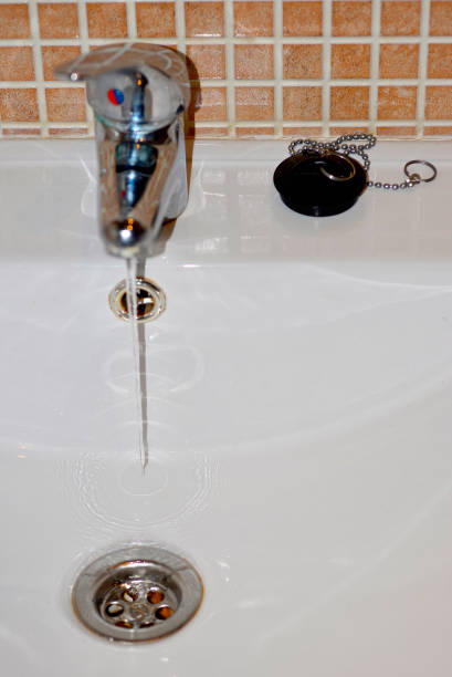 istock drain basin with tap and stopper. White bathroom sink. 1472748856