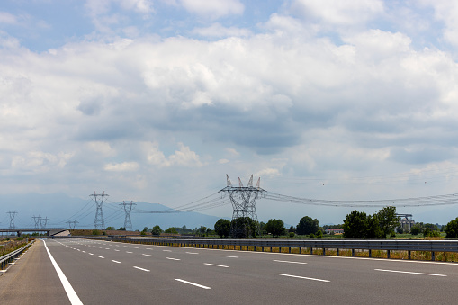 High-voltage power line on the side of the highway