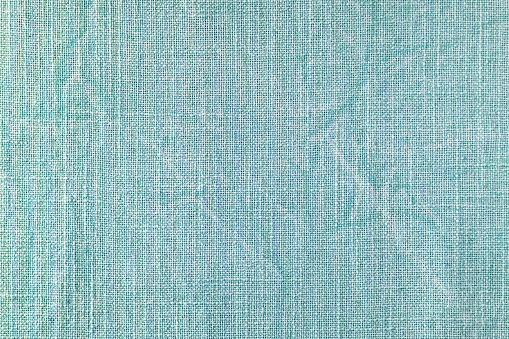 Natural turquoise linen fabric texture background. Flax cloth surface, tablecloth, upholstery, curtains textile. Top view, close up