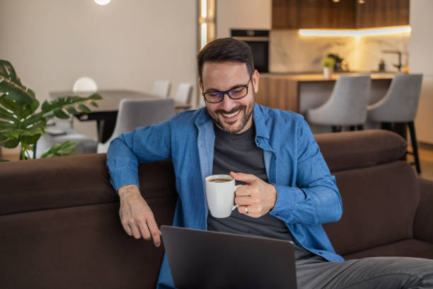 istock Man using laptop, writing email,online meeting or payment online 1472753675