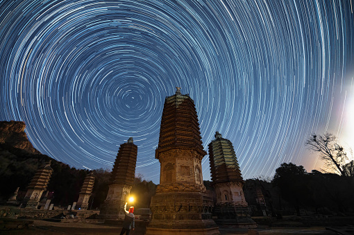 view of asian buddhist pagoda and startrail in galaxy universe，Beijing Yinshan Pagoda Forest.