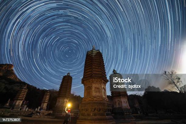 View Of Asian Buddhist Pagoda And Startrail In Galaxy Universe Stock Photo - Download Image Now