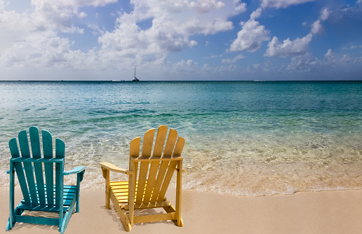 Two wooden chairs on Caribbean coast