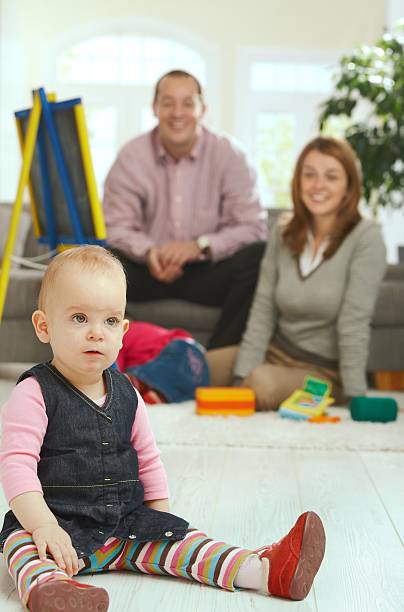 istock Baby sitting on floor 147275458