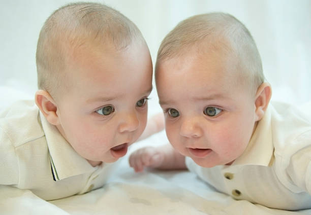 istock baby twins playing on the blanket 147275496
