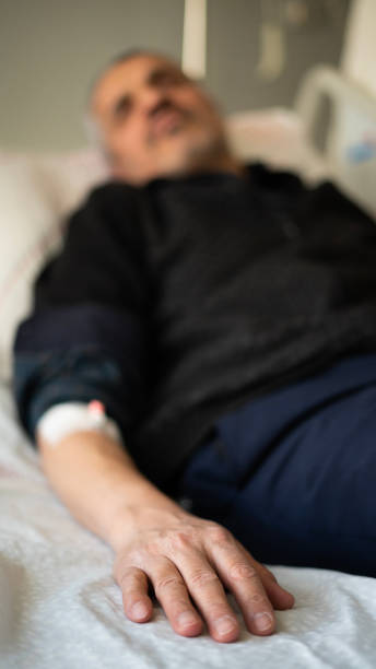 istock Sick old man lying in hospital 1472755292