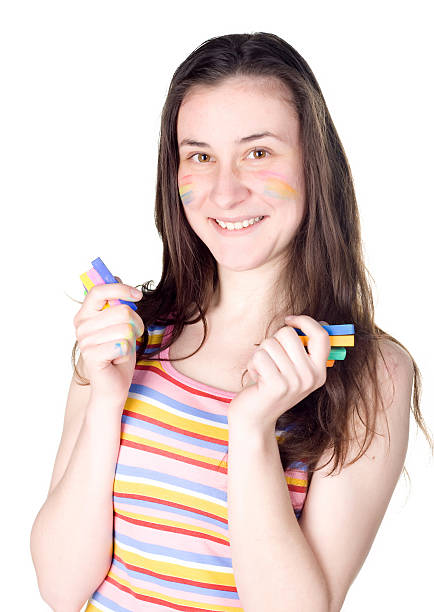 istock smiling girl with colored face showing colour chalks 147275616