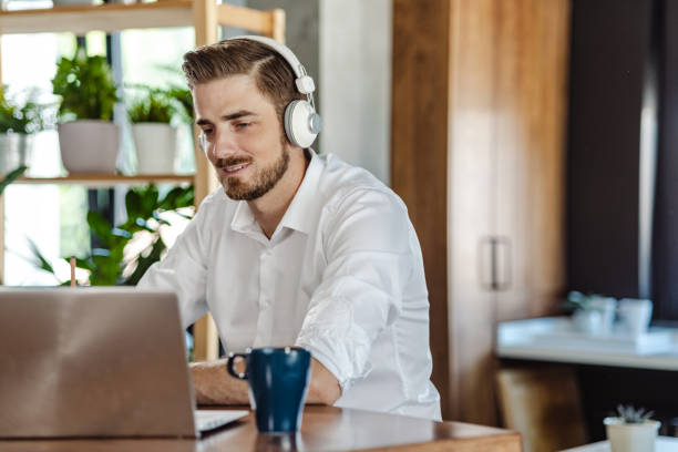 istock Young man working on the laptop at home 1472756803