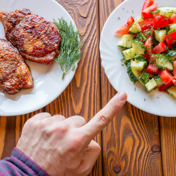 istock vegetarian chooses salad instead of fried meat 1472756929