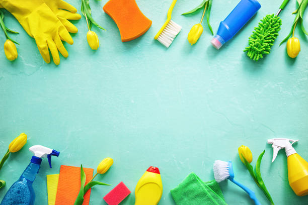 istock Flat lay composition with cleaning supplies, tools and spring flowers on colorful background 1472760314