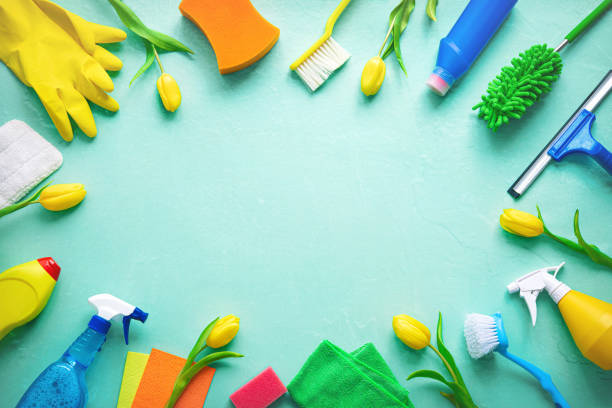 istock Flat lay composition with cleaning supplies, tools and spring flowers on colorful background 1472760318