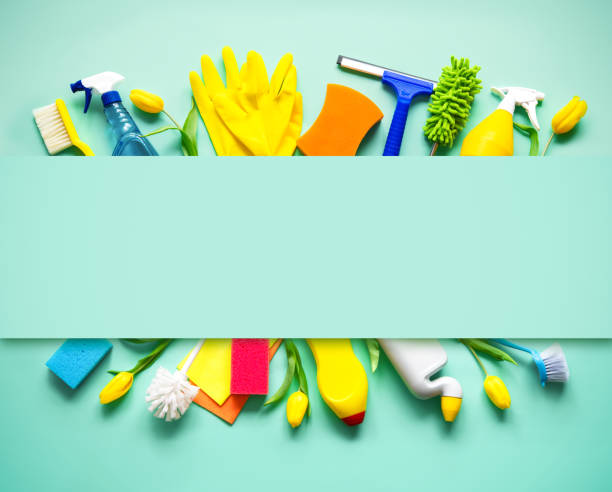 Flat lay composition with cleaning supplies, tools and spring flowers on colorful background