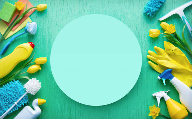 istock Flat lay composition with cleaning supplies, tools and spring flowers on colorful background 1472760320