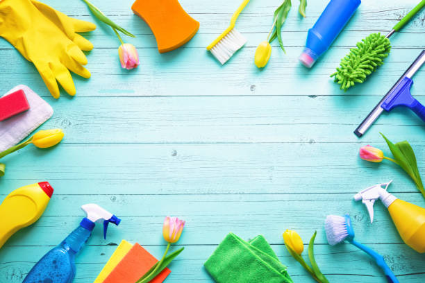 istock Flat lay composition with cleaning supplies, tools and spring flowers on colorful background 1472760321