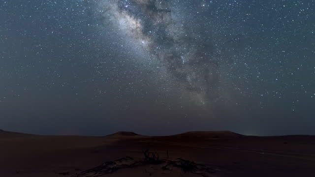 4K Time lapse of milky way on the top of sand dune in the desert.